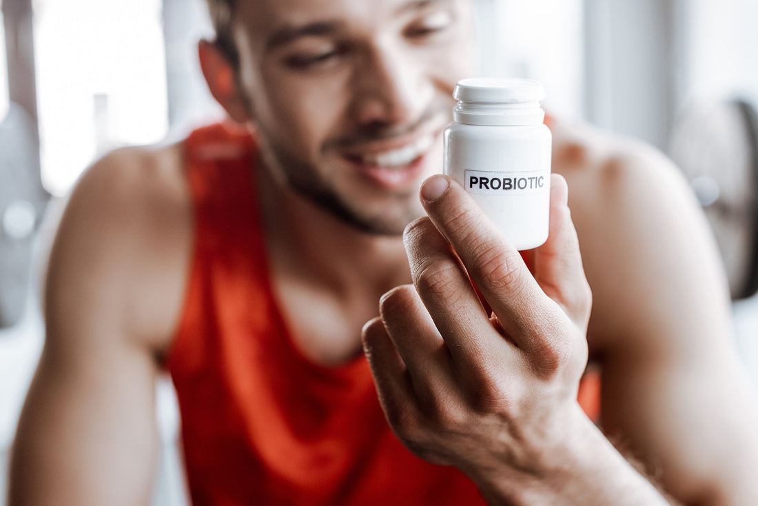 an athlete holding a white jar with the text 'probiotic'