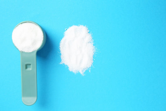 a scooper with white powder in front of a blue background